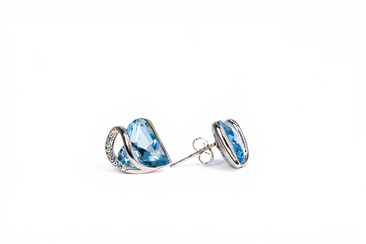 "Sterling silver heart stud earrings with blue crystal on white background"
"Close-up of hypoallergenic silver earrings for women"
"Elegant heart-shaped blue crystal earrings in gift box"