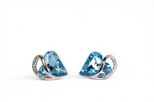 "Sterling silver heart stud earrings with blue crystal on white background"

"Close-up of hypoallergenic silver earrings for women"

"Elegant heart-shaped blue crystal earrings in gift box"
